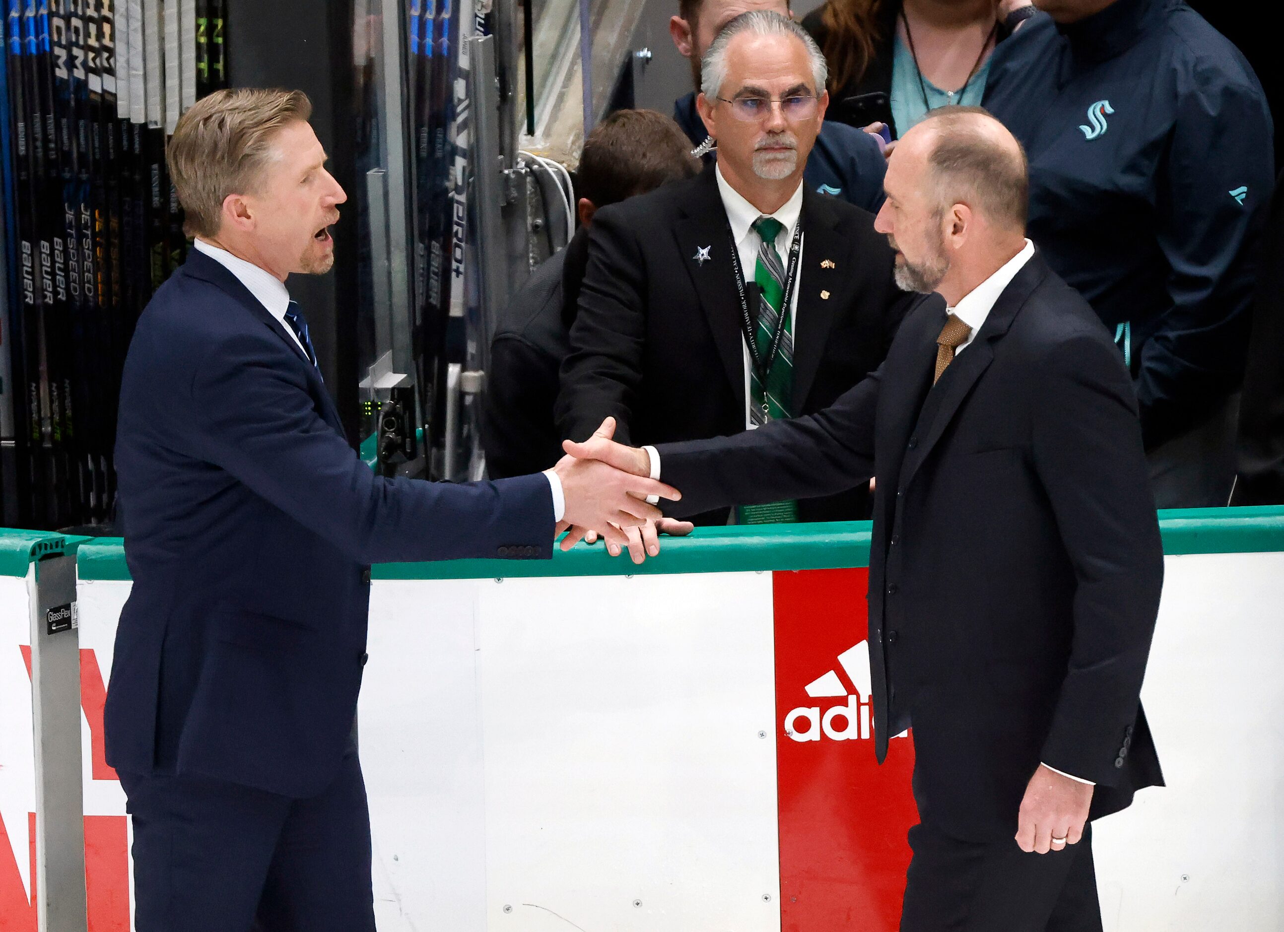 Seattle Kraken head coach Dave Hakstol (left) congratulates Dallas Stars head coach Peter...