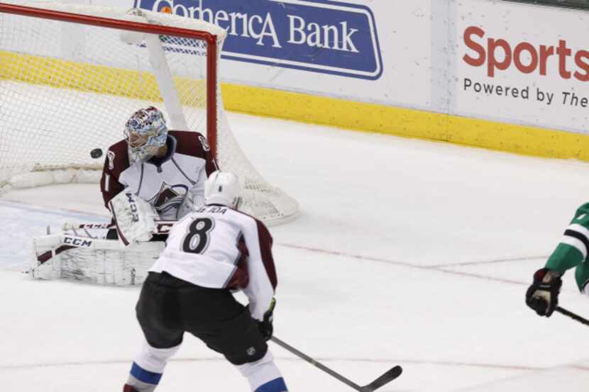 Colorado Avalanche goalie Semyon Varlamov (1) eyes the puck, shot by Dallas Stars center...