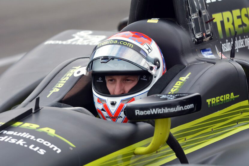 Charlie Kimball sits in his car on pit road during practice for Saturday's IndyCar auto race...