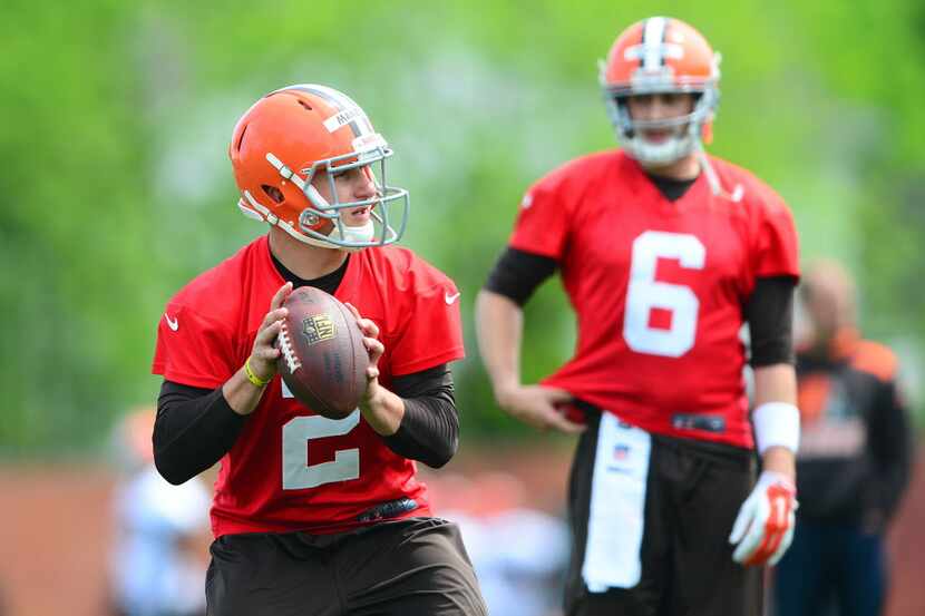 Cleveland Browns quarterback Johnny Manziel (2) looks to pass as quarterback Brian Hoyer (6)...