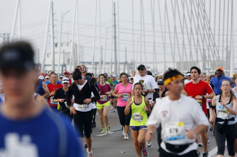 Runners head east across the Margaret Hunt Hill Bridge during the MetroPCS Dallas Marathon...