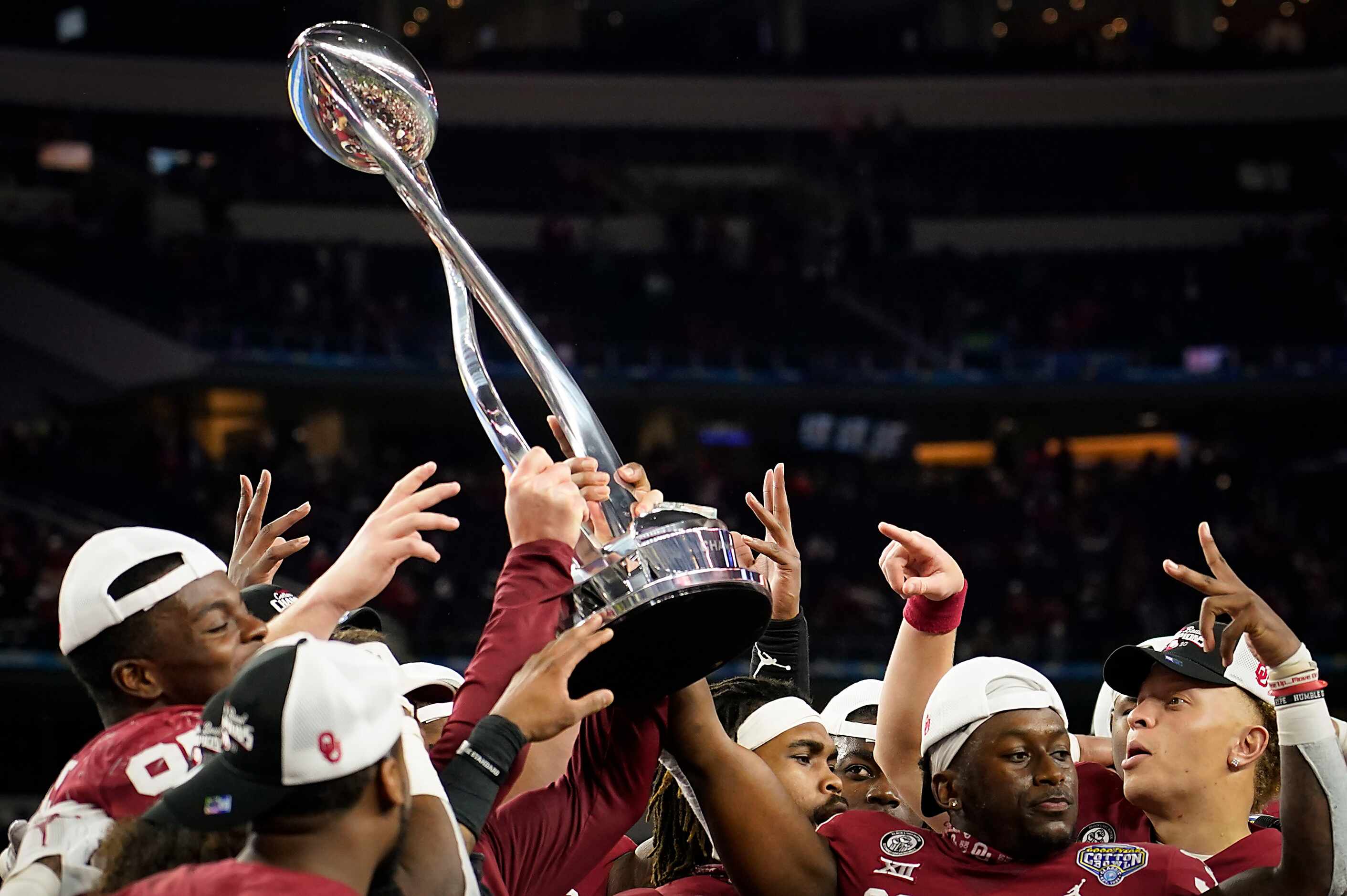 Oklahoma players celebrate with the championship trophy after a victory over Florida in the...