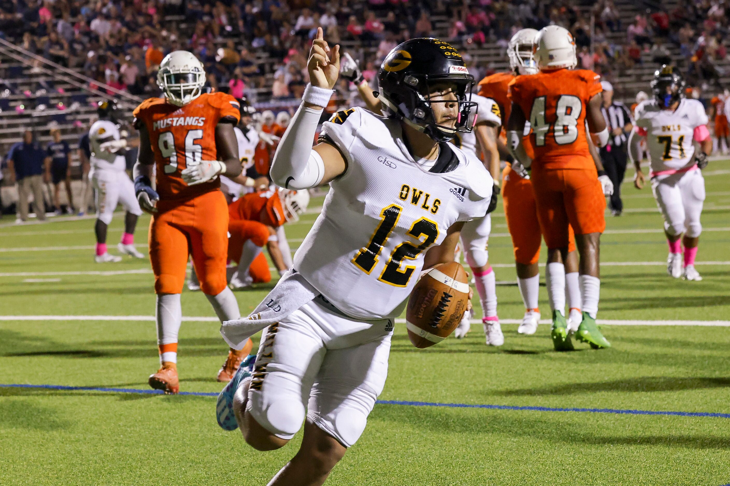 Garland’s quarterback Cergio Perez (12) runs in for a touchdown interceptions during the...