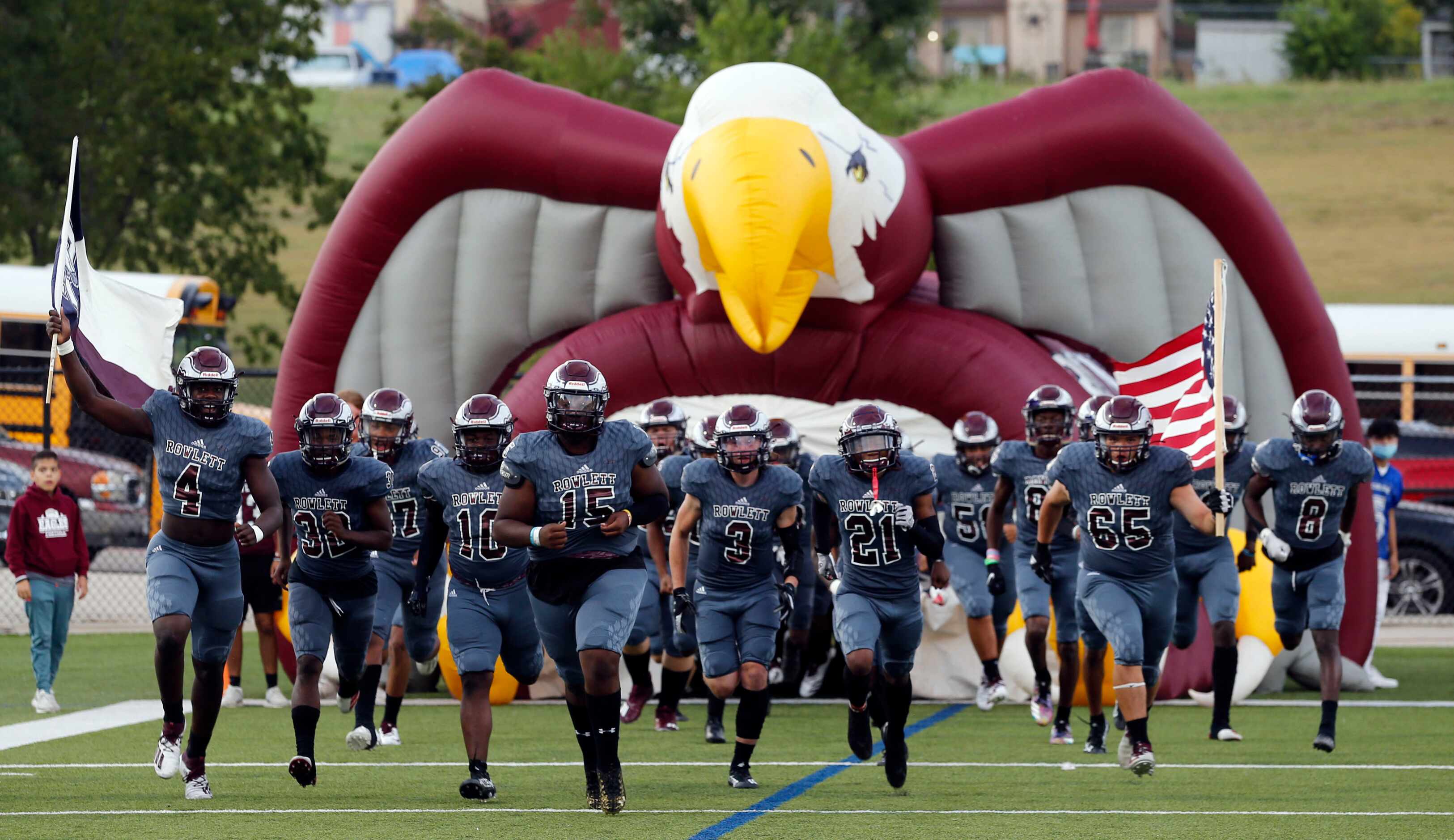 The Rowlett football enters the field before the start of the first half of a high school...