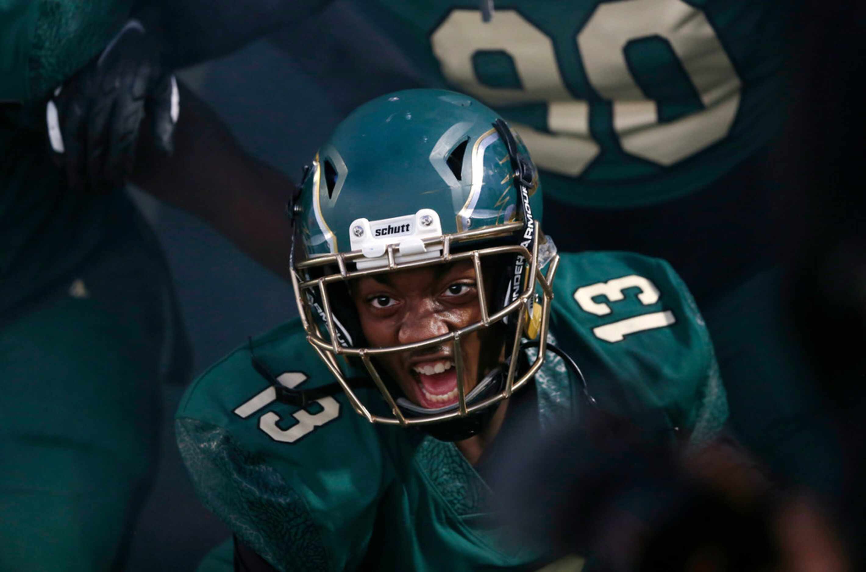 DeSoto's Tyre' Lindsey (13) screams as he prepares tot take the field with the team during...