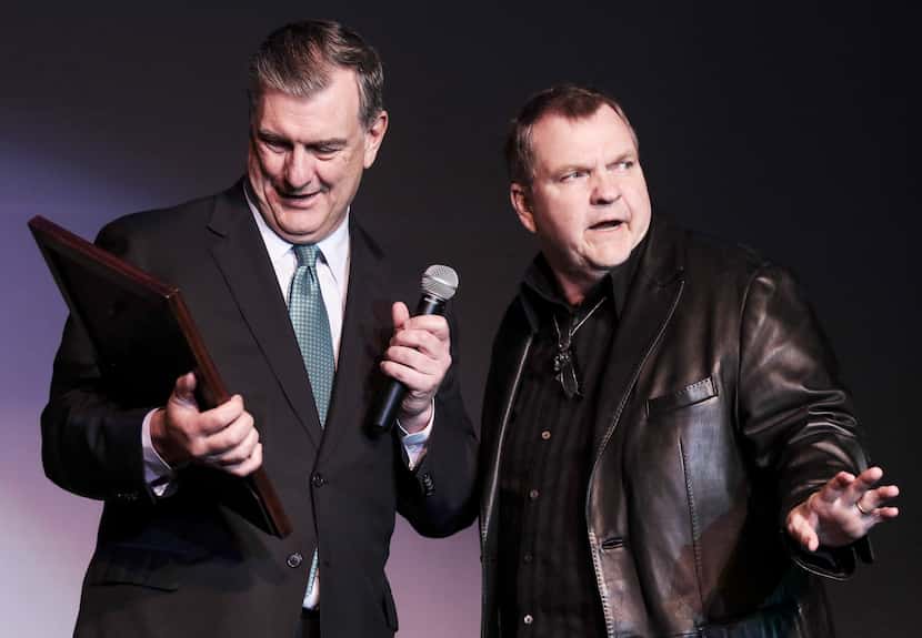 Former Dallas Mayor Mike Rawlings presents a plaque on behalf of the city to Meat Loaf, who...
