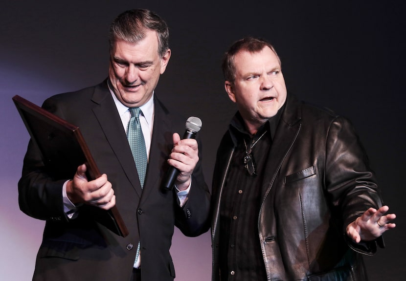 Former Dallas Mayor Mike Rawlings presents a plaque on behalf of the city to Meat Loaf, who...