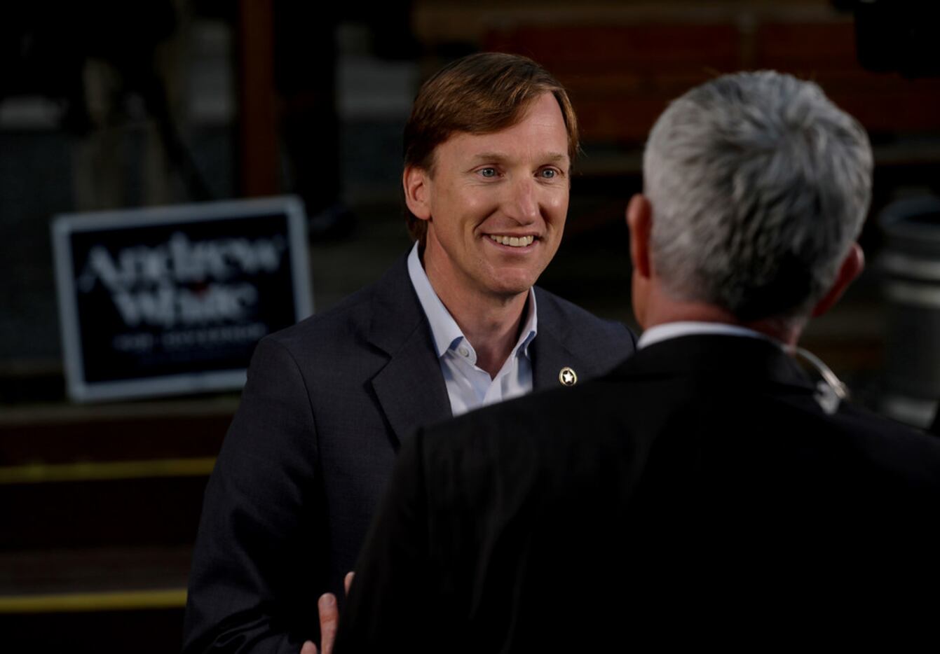 Andrew White, left, a Democratic candidate for governor, talks to a television reporter...