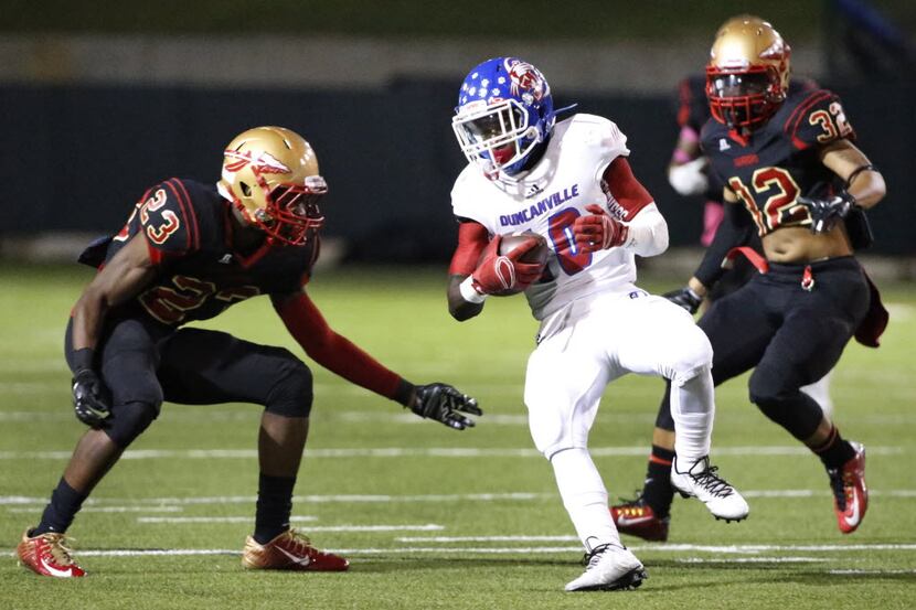 Duncanville's Roosevelt Richmond III tries a spin move to elude South Grand Prairie's...