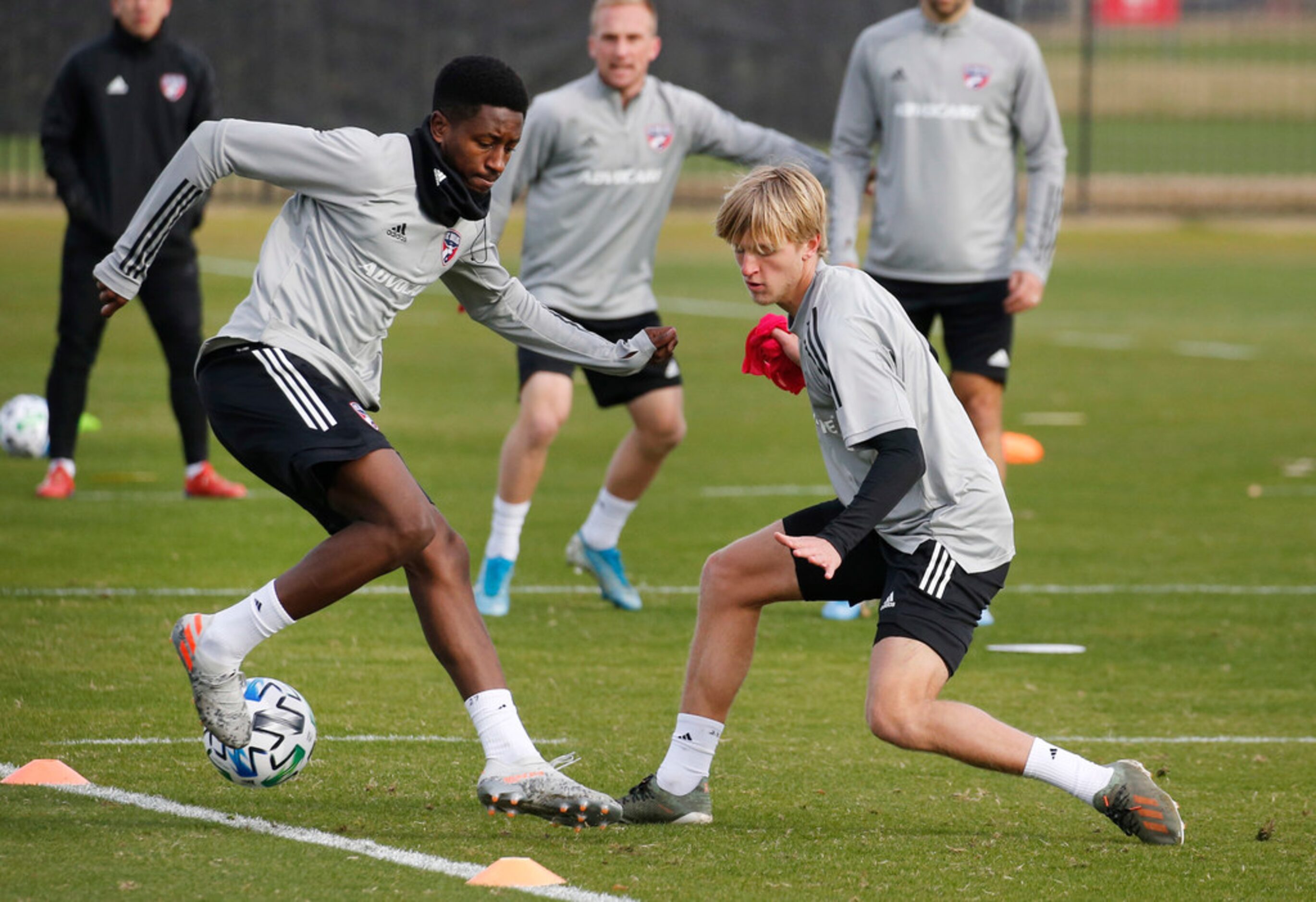 FC Dallas midfielder Eddie Munjoma (27) and FC Dallas midfielder Thomas Roberts (23) compete...