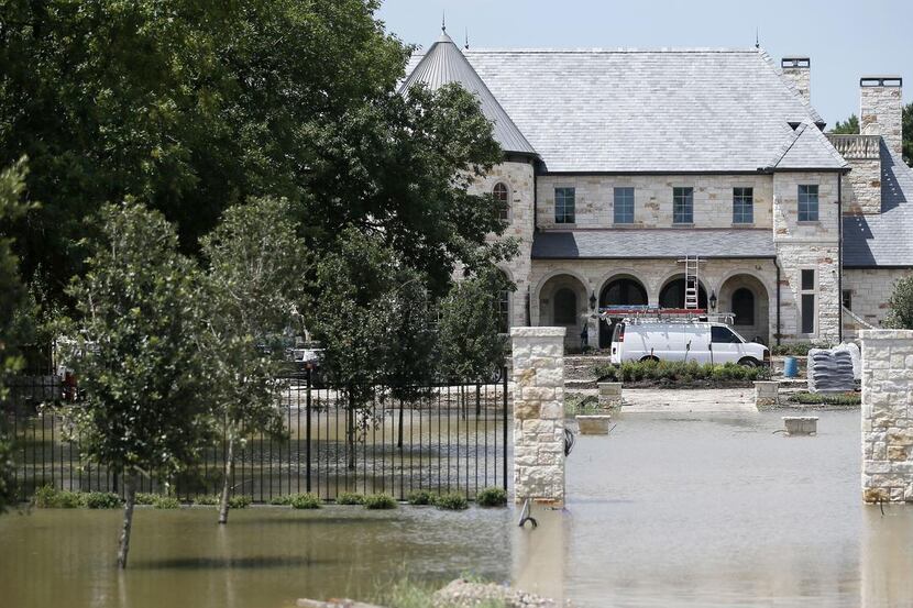 Rising floodwaters  from Denton Creek surrounded a home under construction in Coppell on...