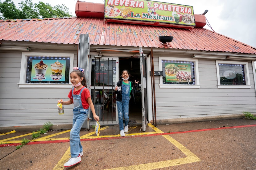 Isabella Melendez (left), 6, and her sister Sophia Melendez, 9, leave La Mexicana Neveria y...