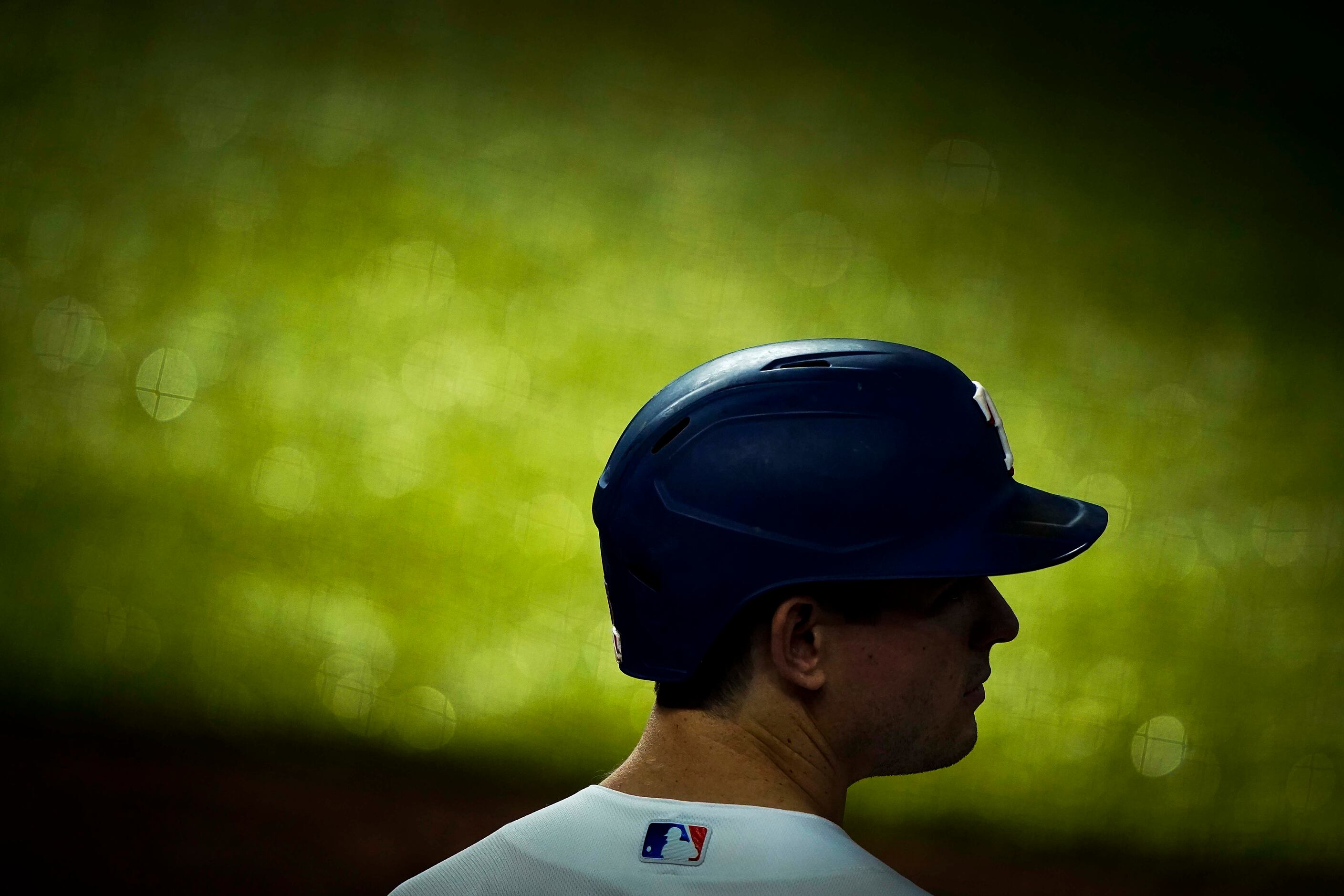 Sunlight filters across the warning track as outfielder Nick Solak waits his turn to bat in...