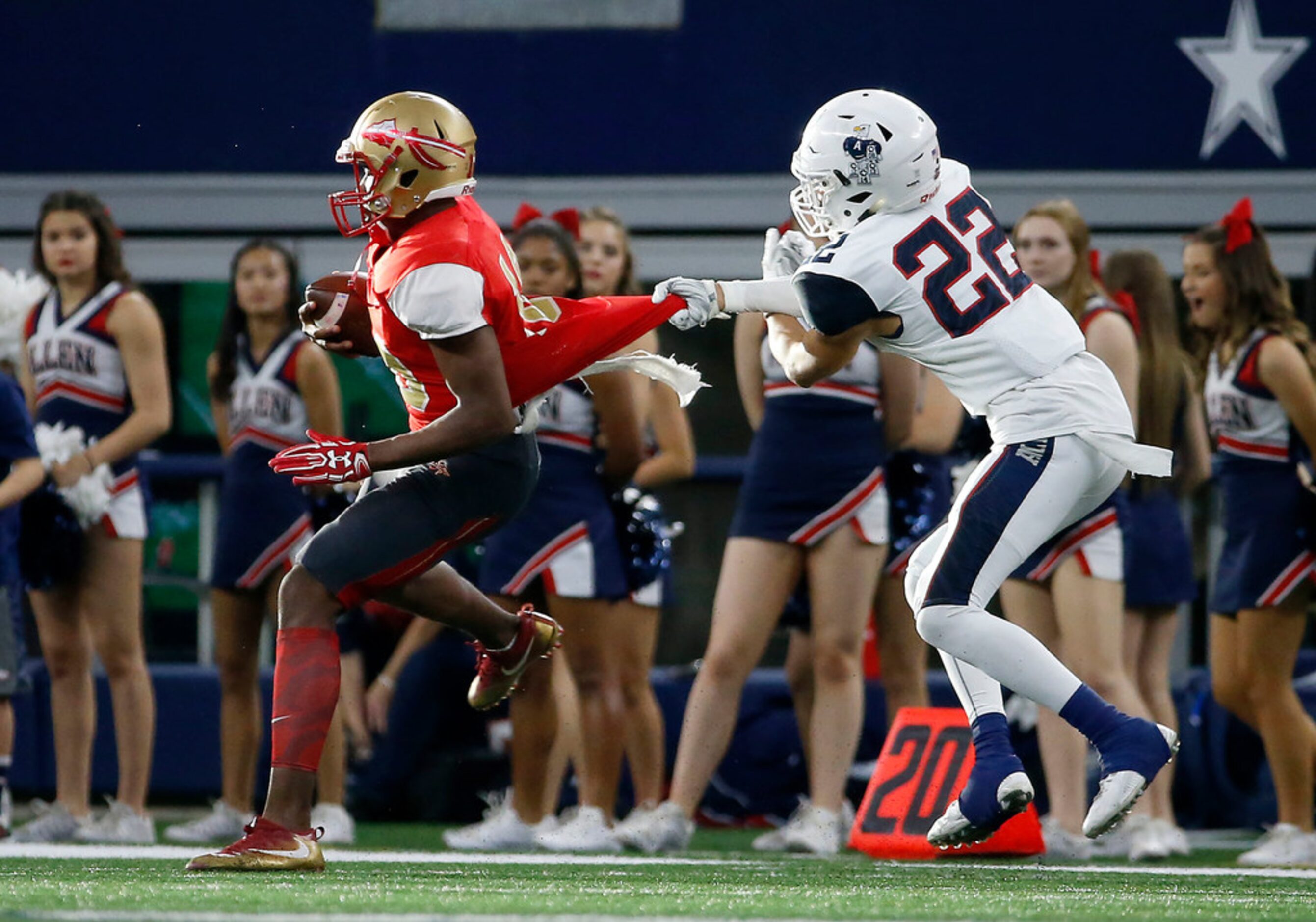 Allen's Taj Bickham (22) pulls a jersey of South Grand Prairie quarterback Nakia Brown...