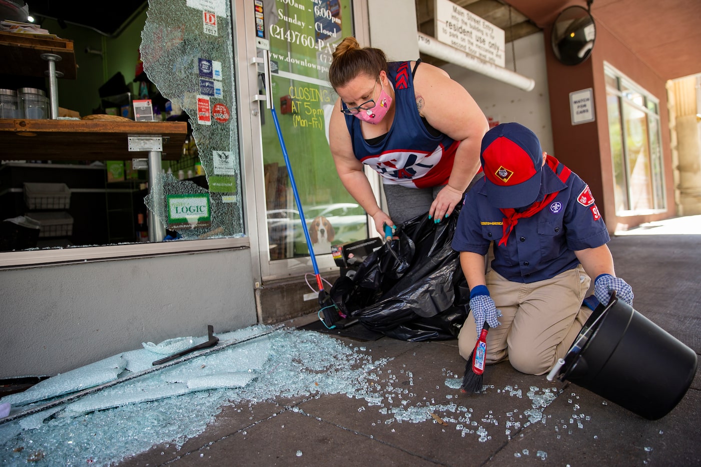 Julie Farmer from Seagoville, TX, and her son Kinsler Farmer, 7, volunteer to clean up after...