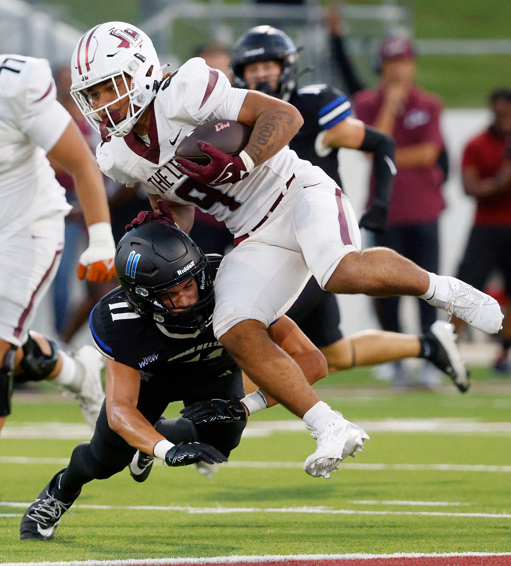 Lewisville's Tenel Hill (9) is tackled by Byron Nelson's Leo Almanza (11) during the first...