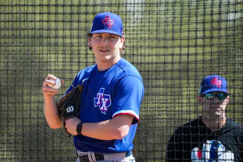 Texas Rangers pitcher Spencer Howard throws live batting practice during a spring training...