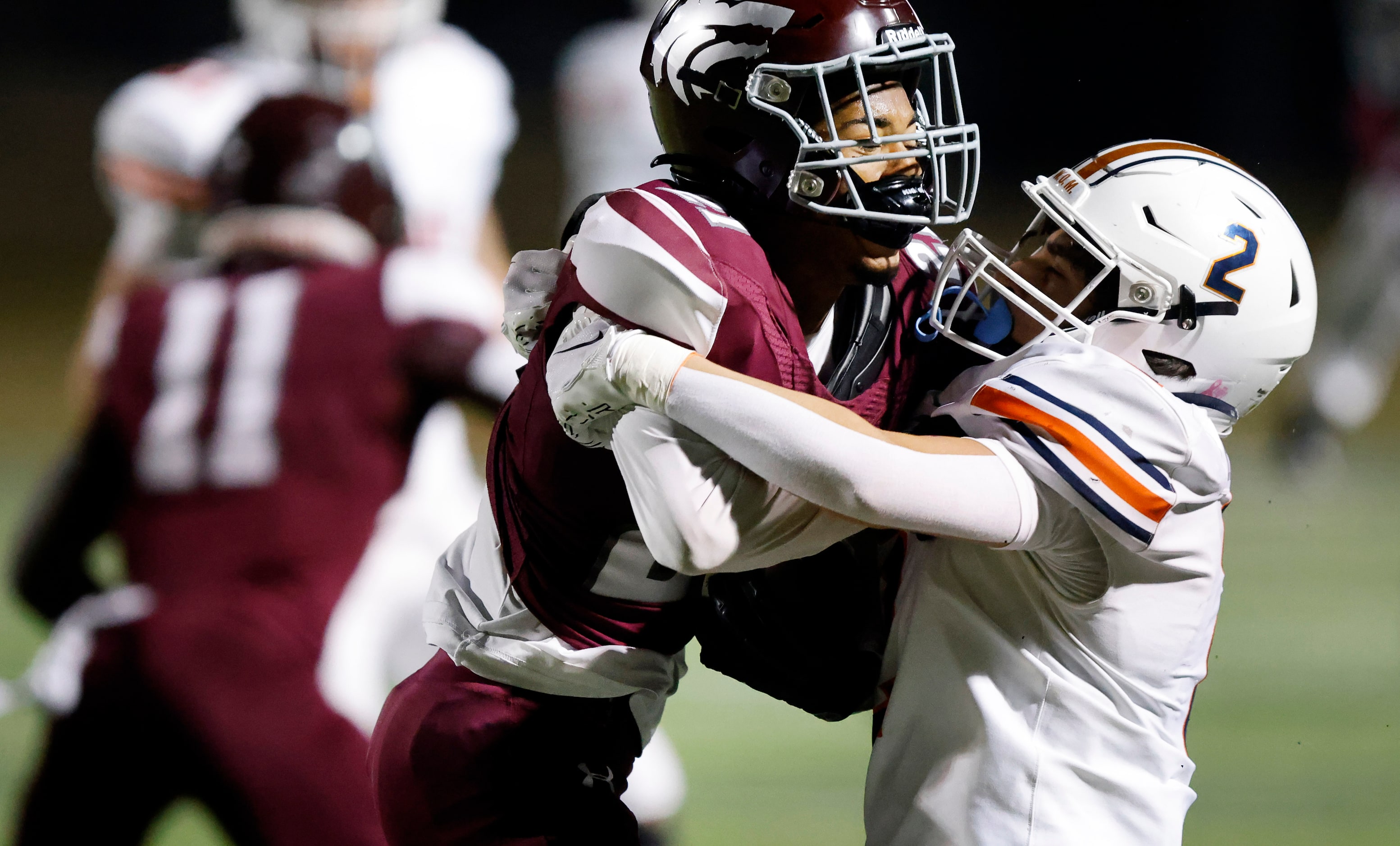 Mansfield Timberview defensive back Landon Blair (21) is taken down by Frisco Wakeland...