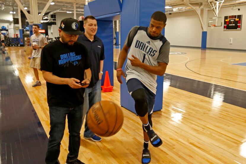 Dallas Mavericks first round pick Dennis Smith Jr. (right) leaves the ball on the floor on...
