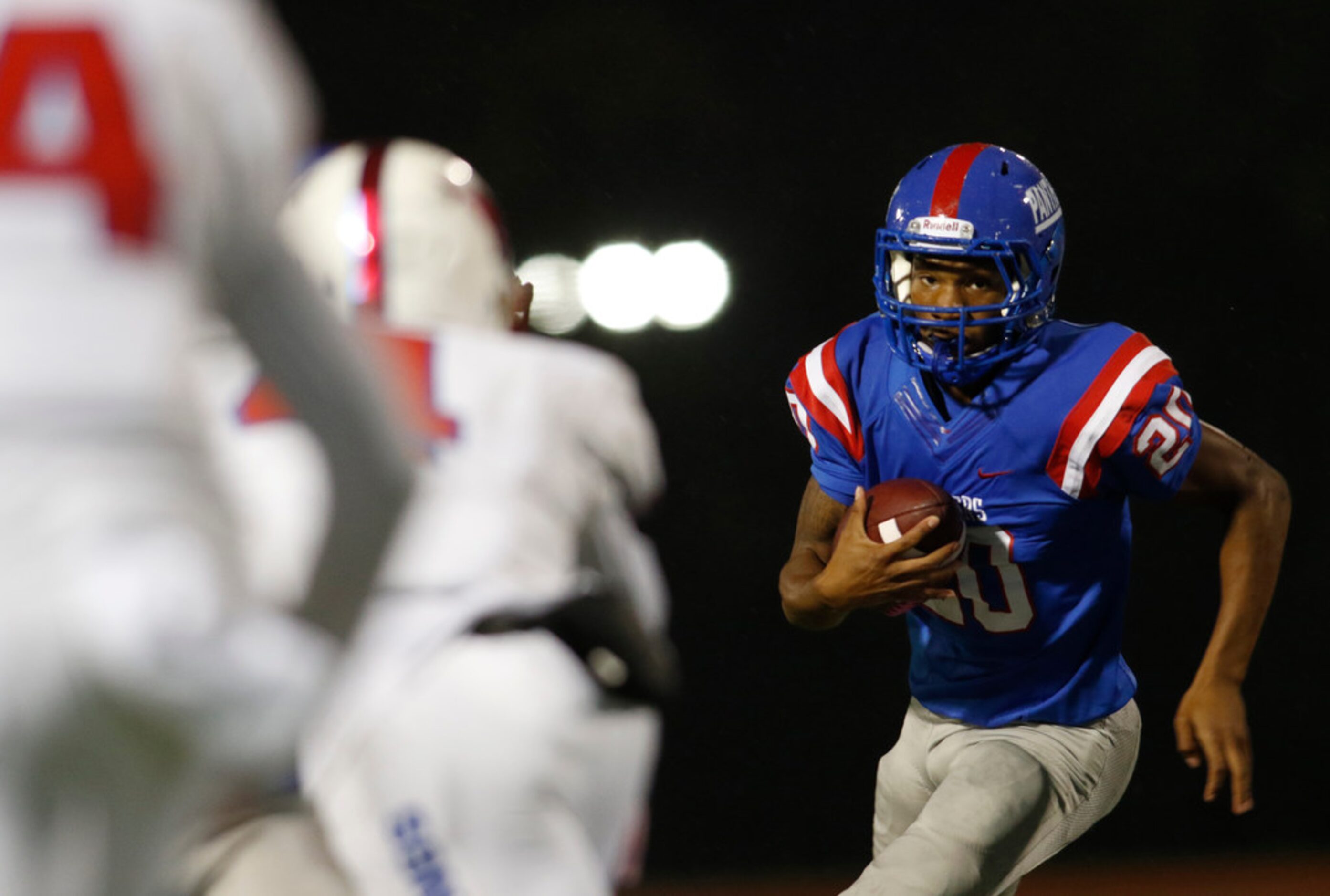 Duncanville running back Javon Fountain (20) eyes the Richardson Pearce defense as he rolls...