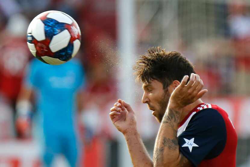 FC Dallas midfielder Ryan Hollingshead (12) heads the soccer ball during the first half as...