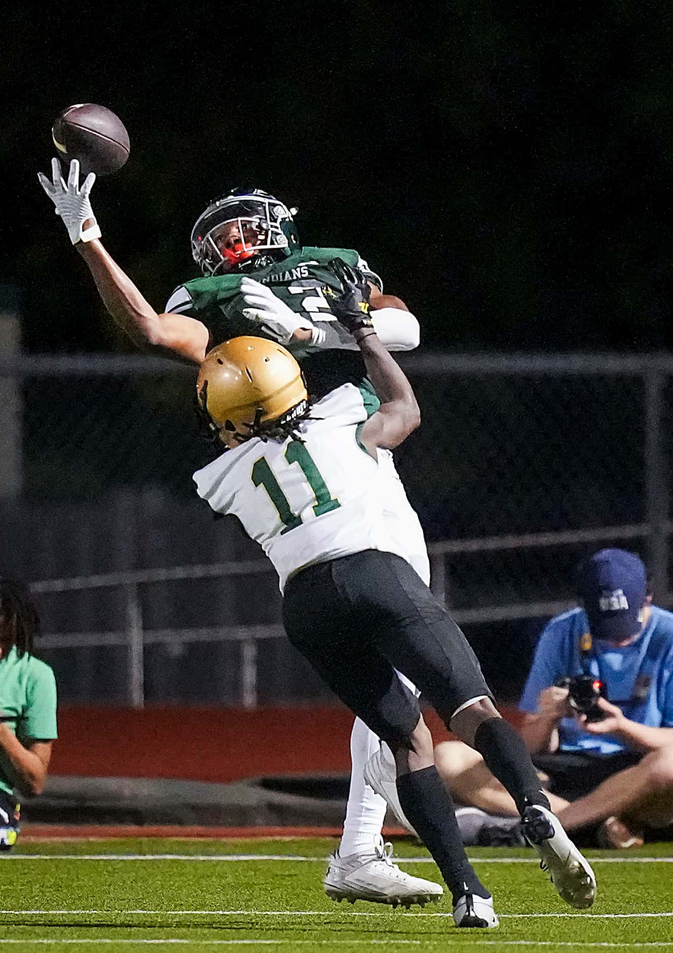 Waxahachie wide receiver Michael Esparza Jr. (12) tips the ball up and comes down with a...