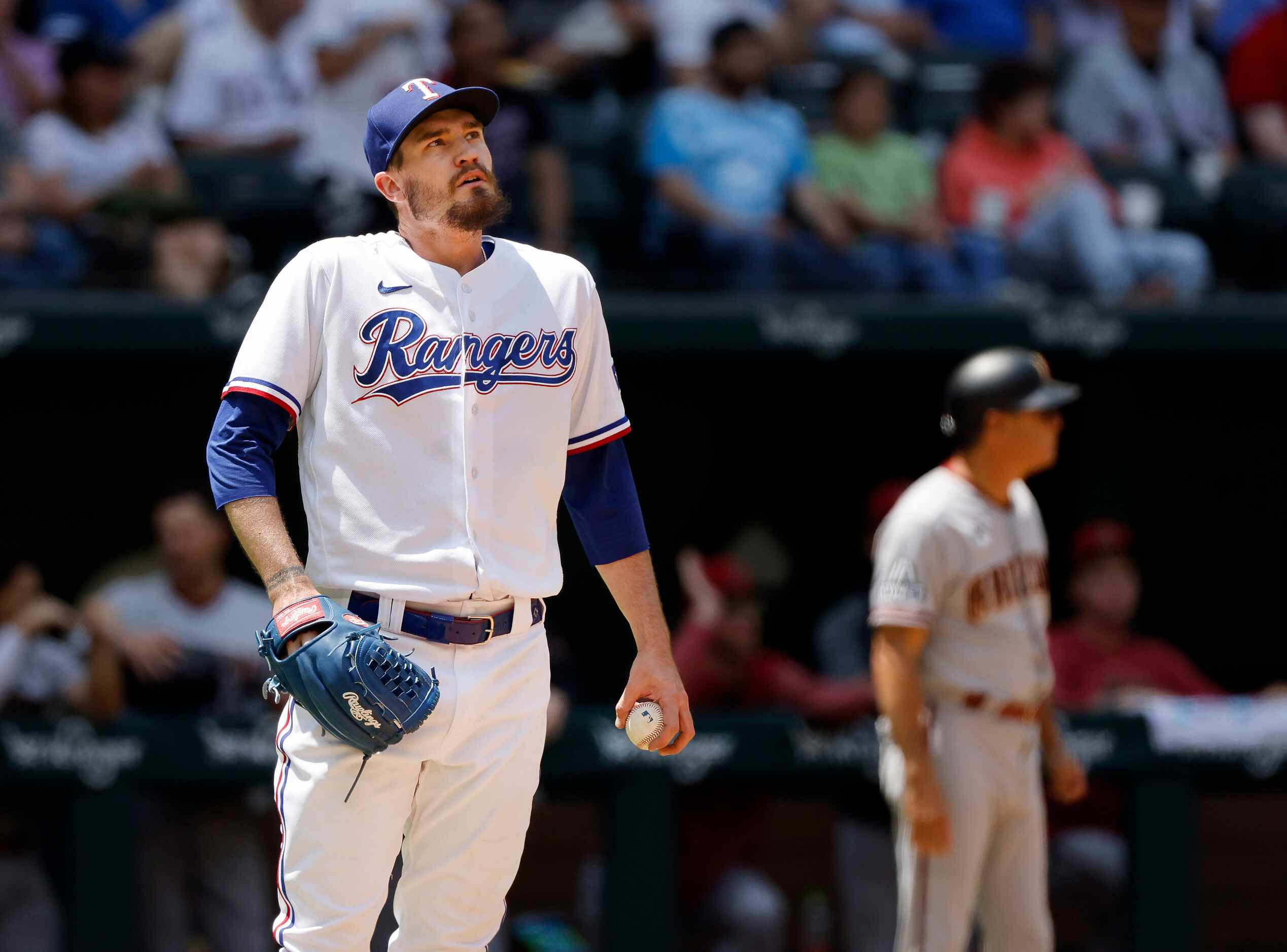 Texas Rangers starting pitcher Andrew Heaney (44) reacts after giving up a solo home run to...