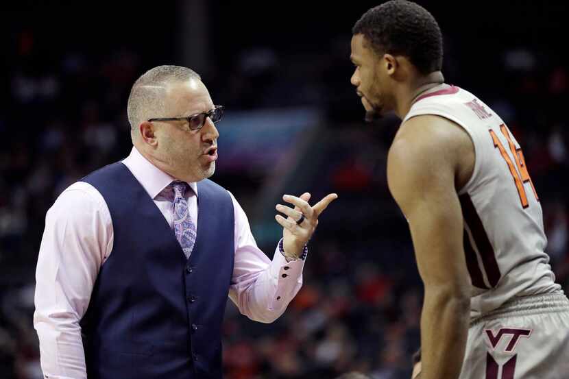 Virginia Tech head coach Buzz Williams, left, talks with P.J. Horne, right, during the...