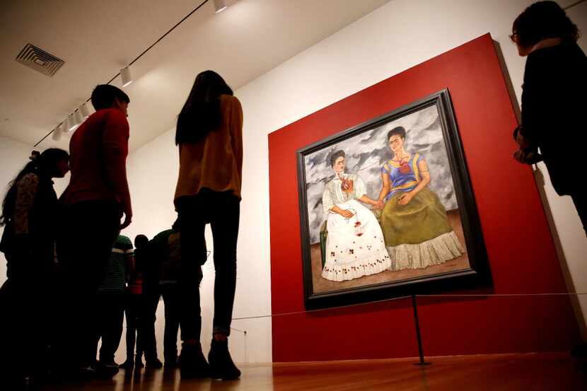 A crowd gathers to look at "The Two Fridas" by Frida Kahlo in the "Mexico 1900-1950: Diego...