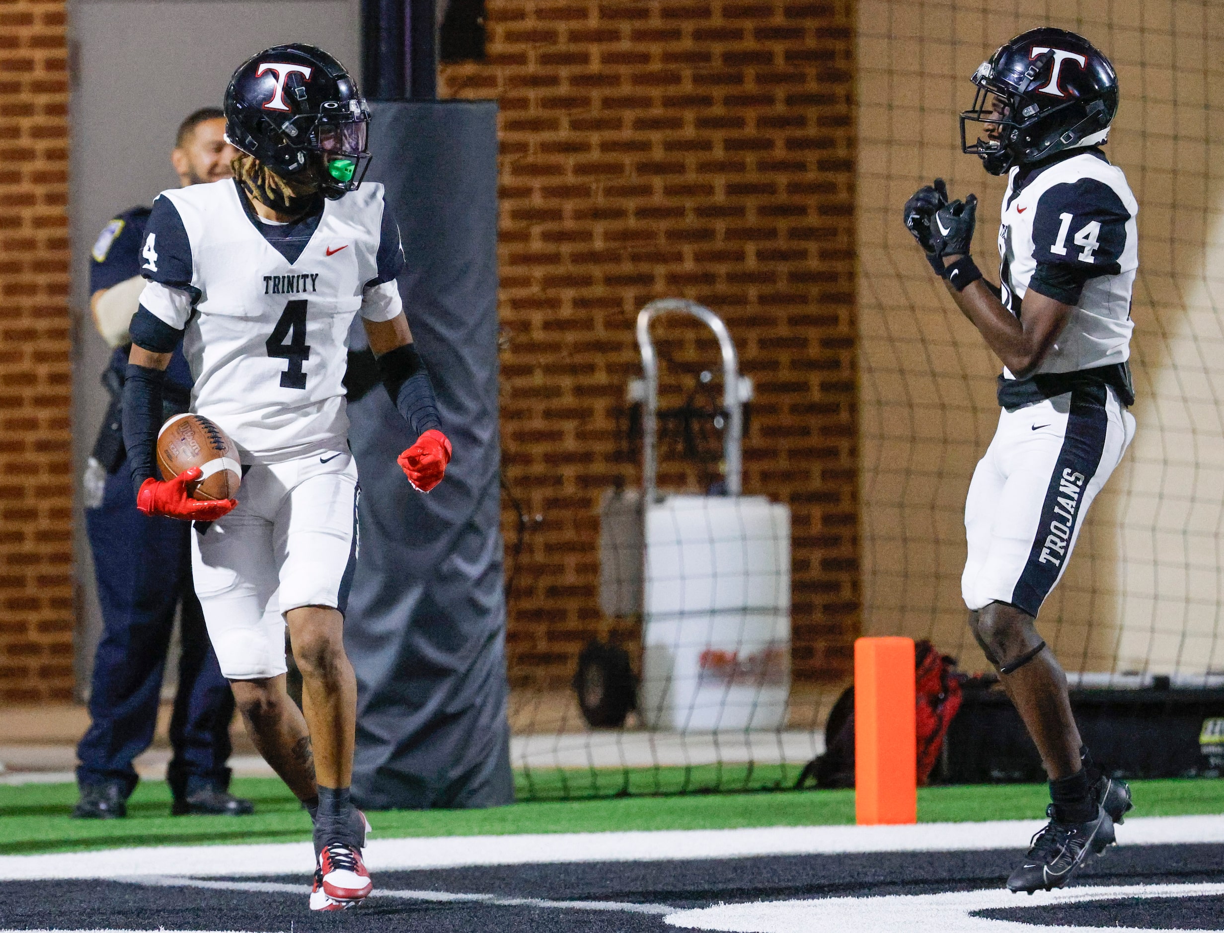 Trinity High’s Jarvis Heimuli (left) and Kaleb Robinson celebrate after scoring a touchdown...