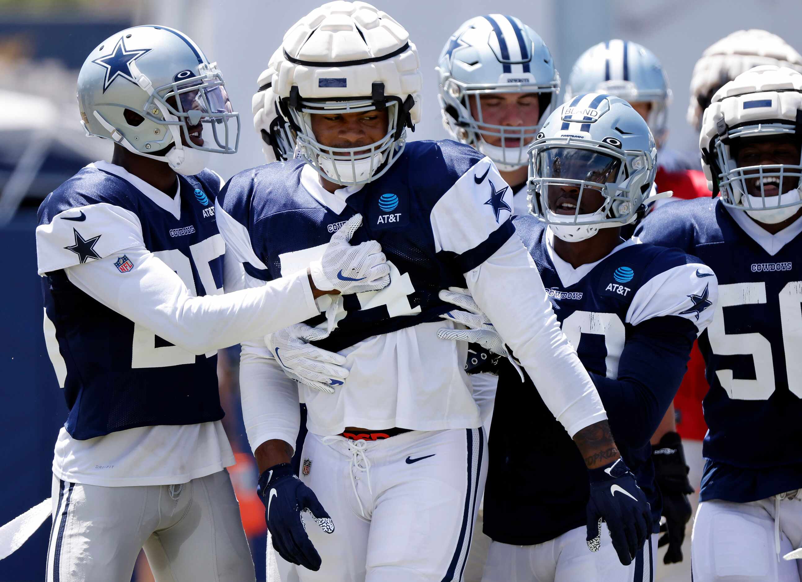 Dallas Cowboys defensive end Sam Williams (54) is pulled away by teammates after scuffling...