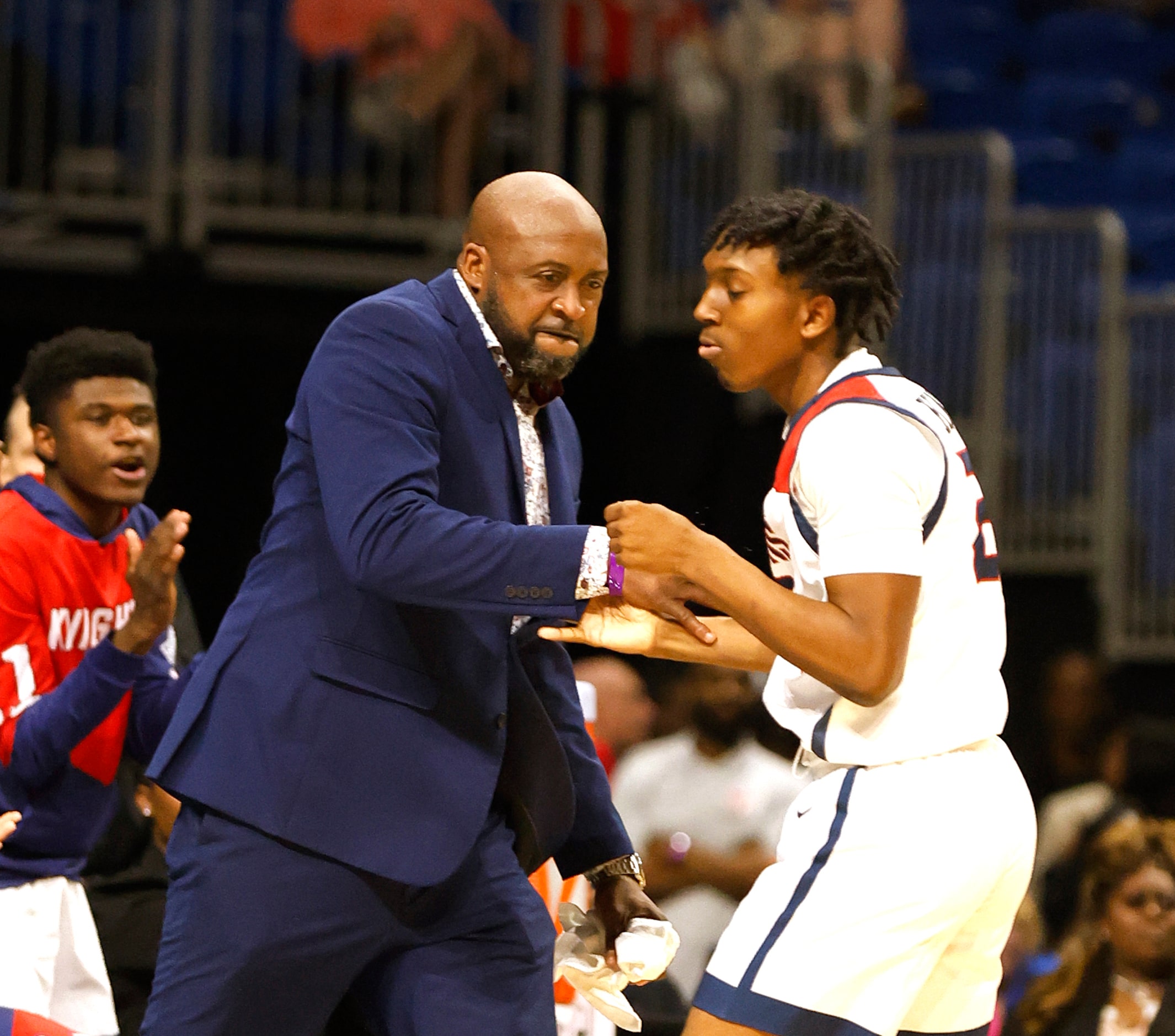 Dallas Kimball head coach Nicke Smith congratulates Dallas Kimball Jalen R. Johnson (23)...