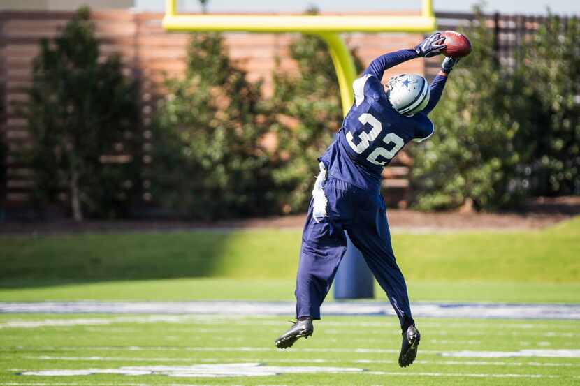 Dallas Cowboys cornerback Orlando Scandrick reaches for a pass during the team's practice at...