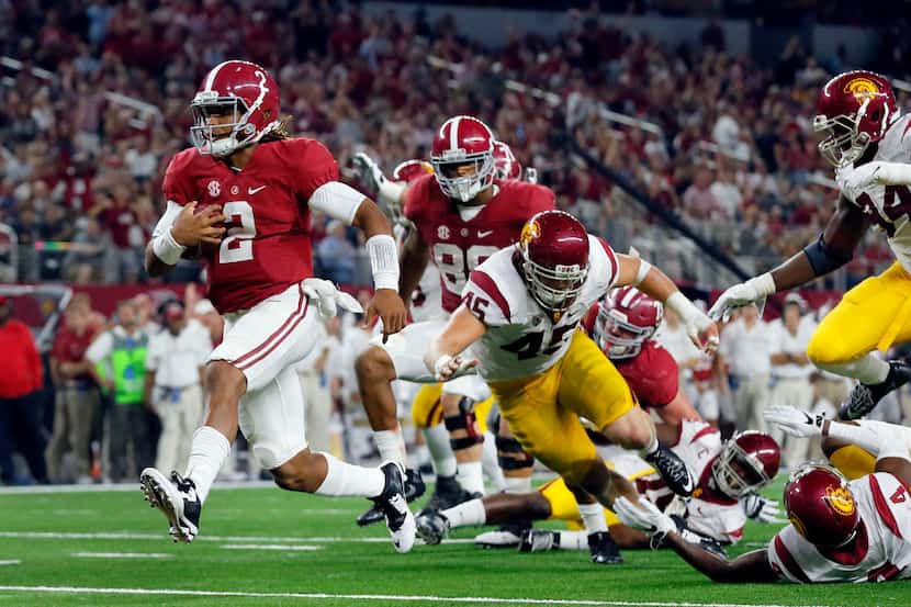 FILE - In this Sept. 3, 2016, file photo, Alabama quarterback Jalen Hurts slips into the end...