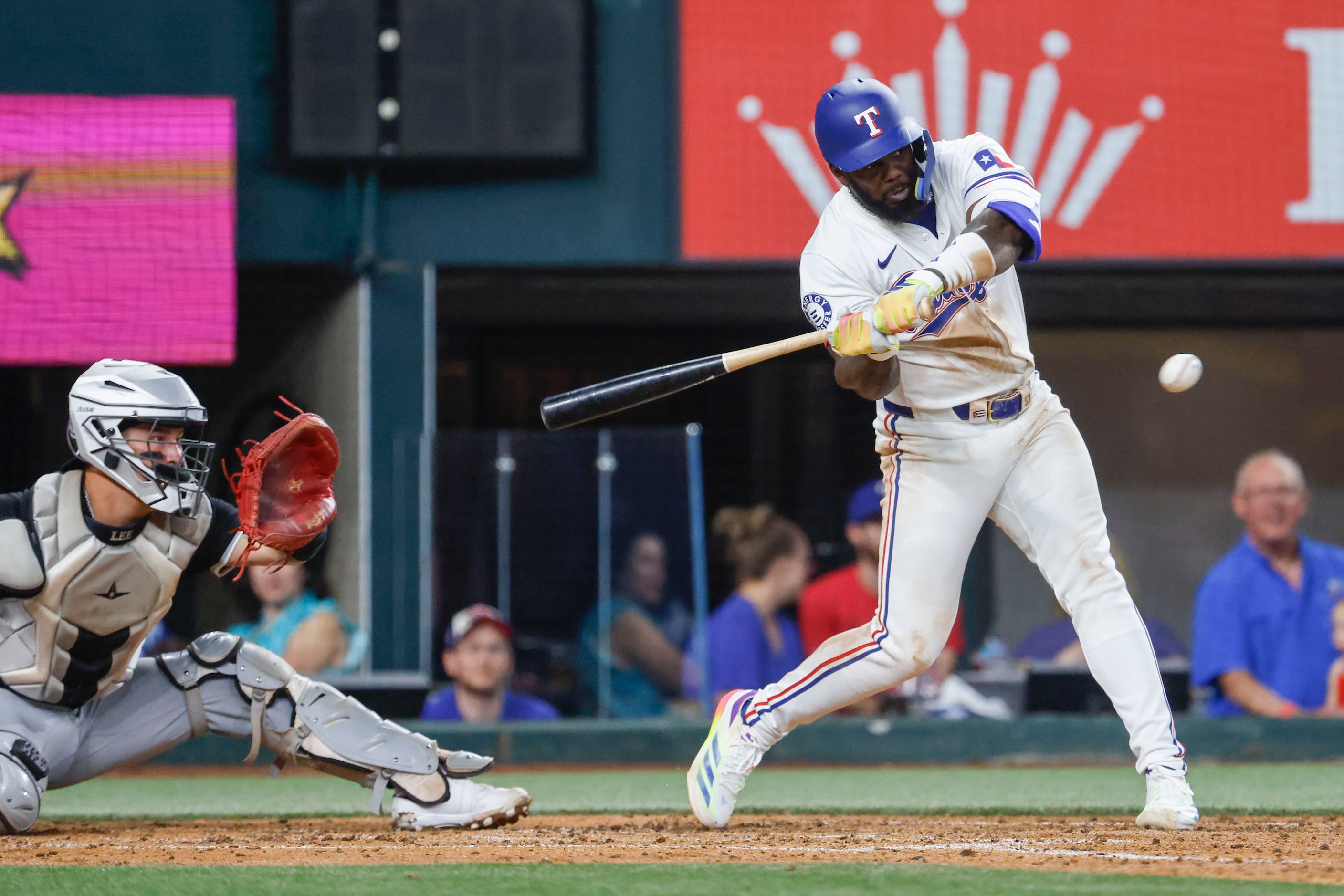 Texas Rangers' Adolis Garcia swings for a strike out against the Chicago White Sox during...