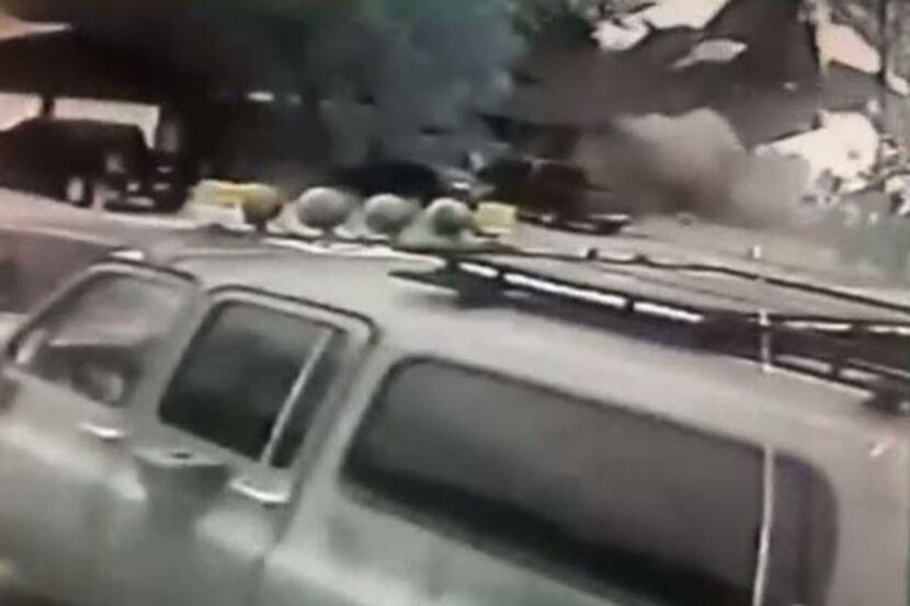 A house in Hurst can be seen exploding in the background in this raw footage obtained by...