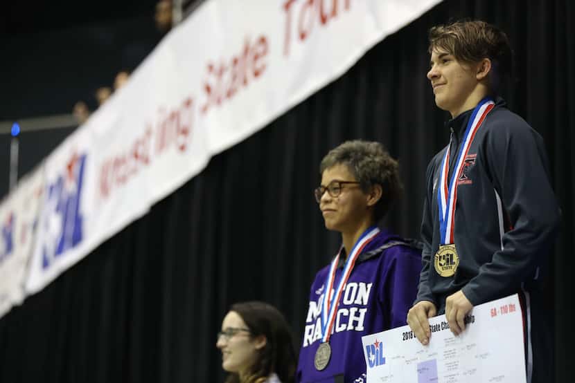 Euless Trinity's Mack Beggs (far right), a transgender male, stands at the podium after...
