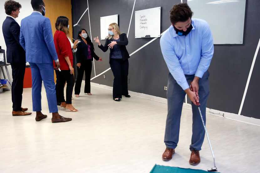 Lumos Marketing Group employees work on a team-building exercise as account executive Pierce...