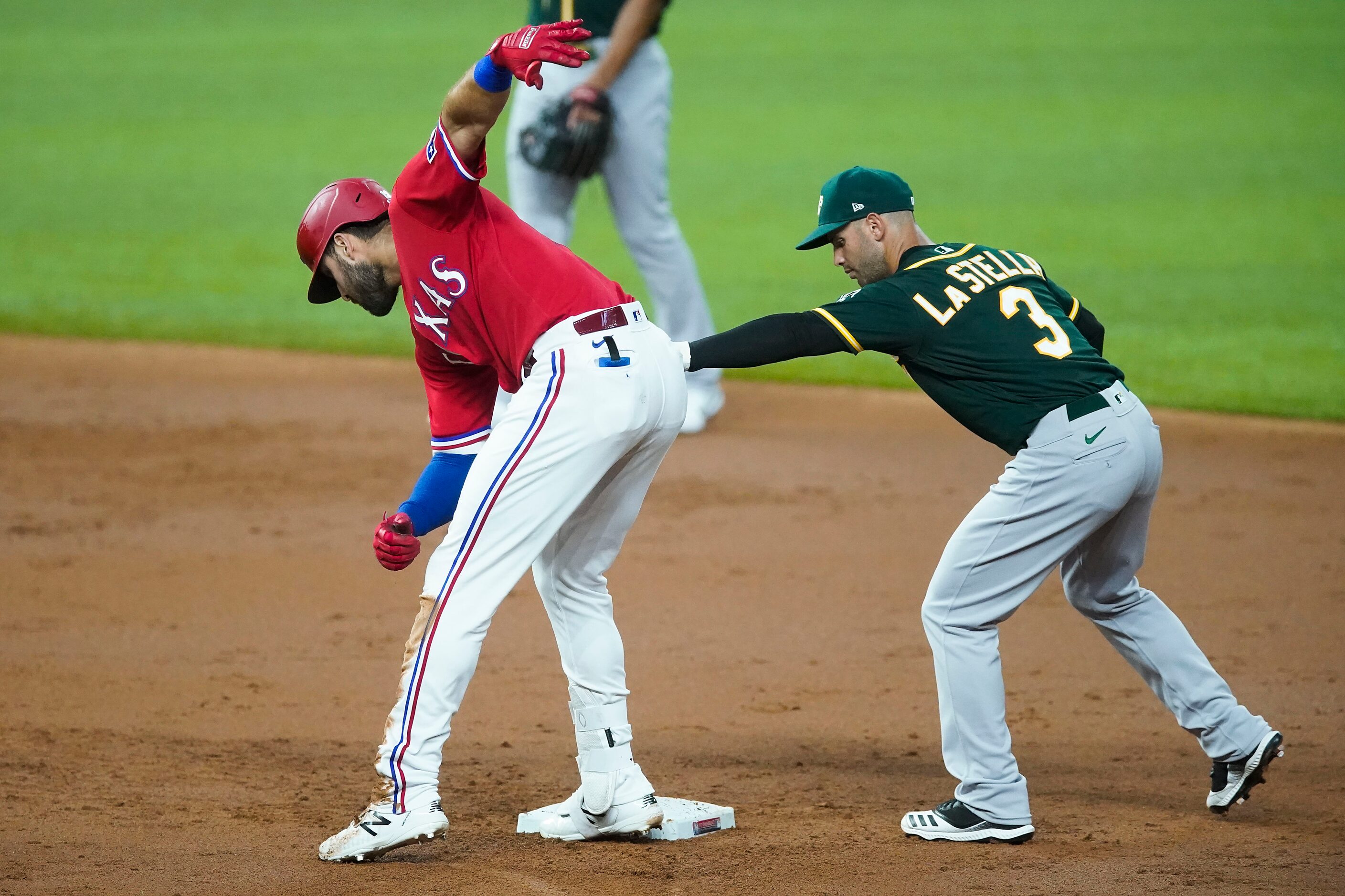 Texas Rangers right fielder Joey Gallo is safe with a double ahead of the tag from Oakland...