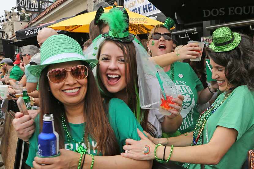 Friends pose as they enjoy beverages during the Lower Greenville Avenue St. Patrick's Day...