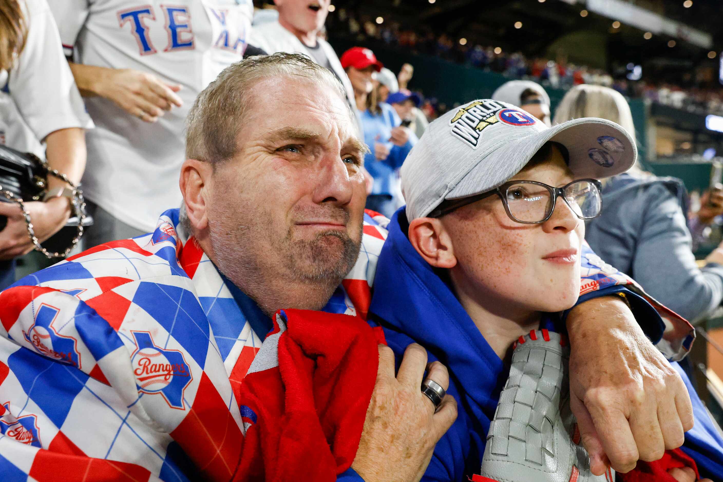 Texas Rangers fan from 1972, Terry Cox, (left) from Tyler, TX, gets emotional embracing his...