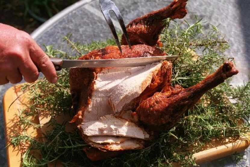 John Bass demonstrates carving a deep-fried turkey.