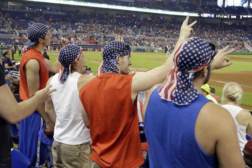 Baseball fans wear American flag-print scarves on Memorial Day weekend during a Marlins and...