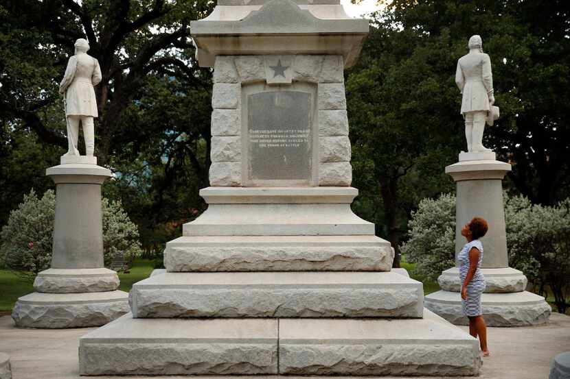 Victoria Miller of Dallas reads an inscription on the Confederate War Memorial in Pioneer...