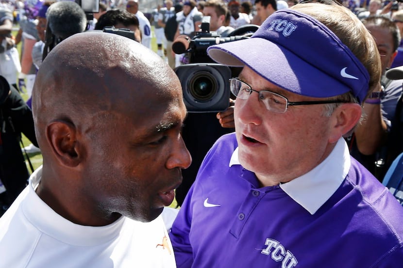 Texas head coach Charlie Strong, left, meets with TCU head coach Gary Patterson, right,...