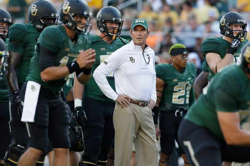Baylor head coach Art Briles watches his team warm up before an NCAA college football game...