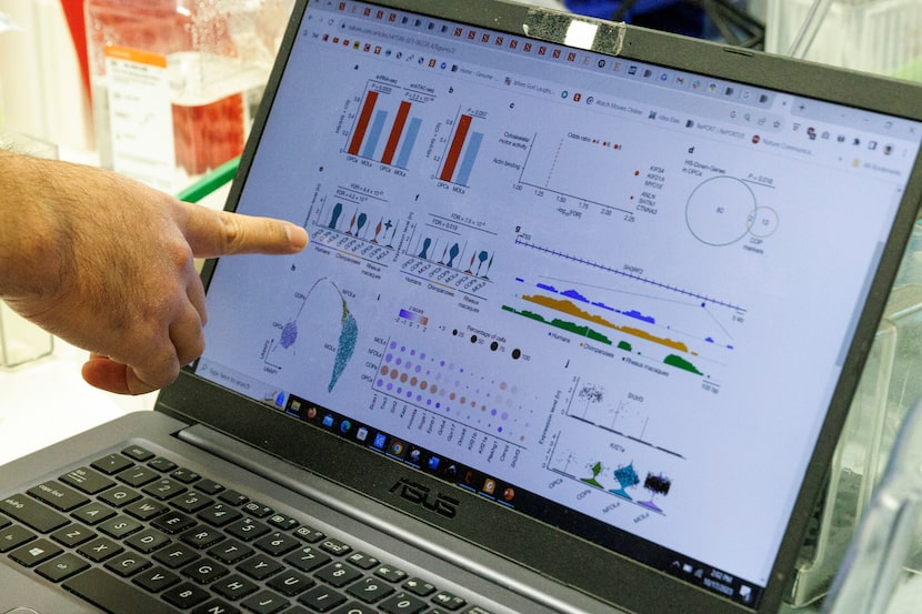 Graduate student Emre Caglayan talks through his research about brain cells in a lab at the...