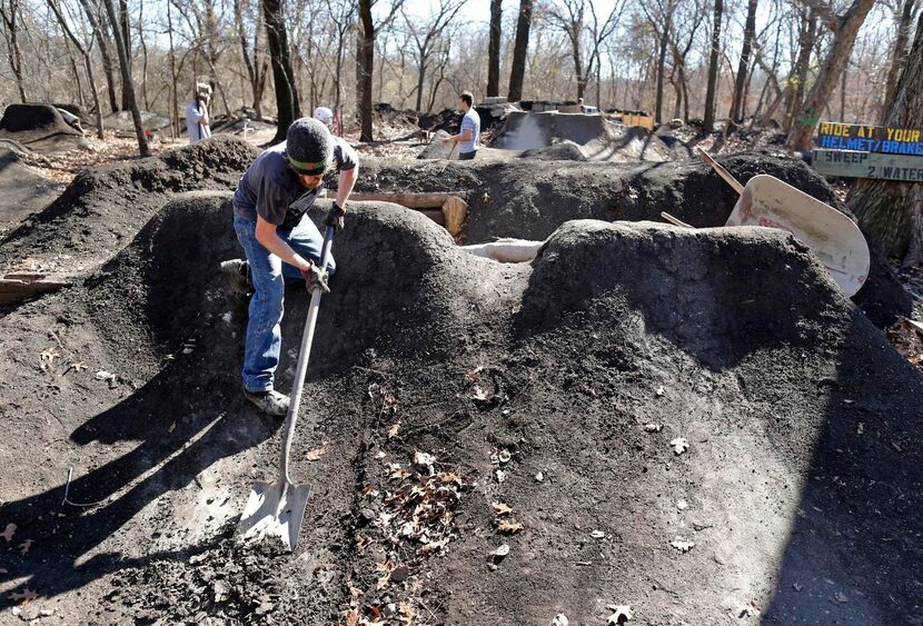 
Trail steward Barry Bishop of Richardson worked on one of the jumps at The Woods at Katie...