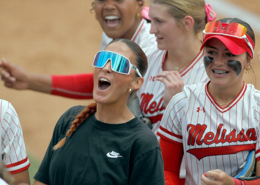 Melissa head coach Cassie Crabtree, center shares her enthusiasm with her players at the end...