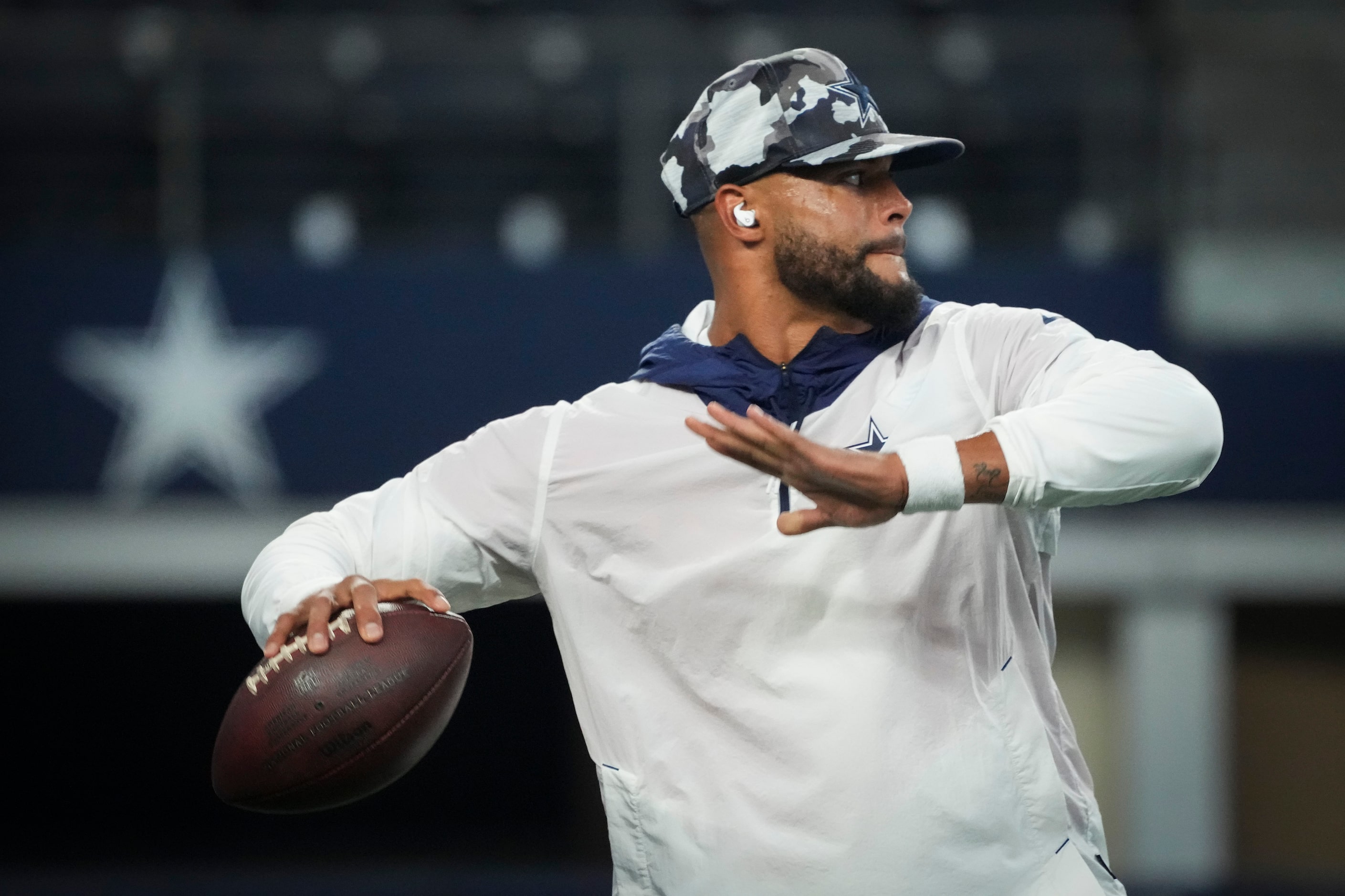 Dallas Cowboys quarterback Dak Prescott warms up before an NFL preseason football game...